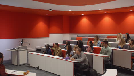 male teacher in lecture theatre presenting to students