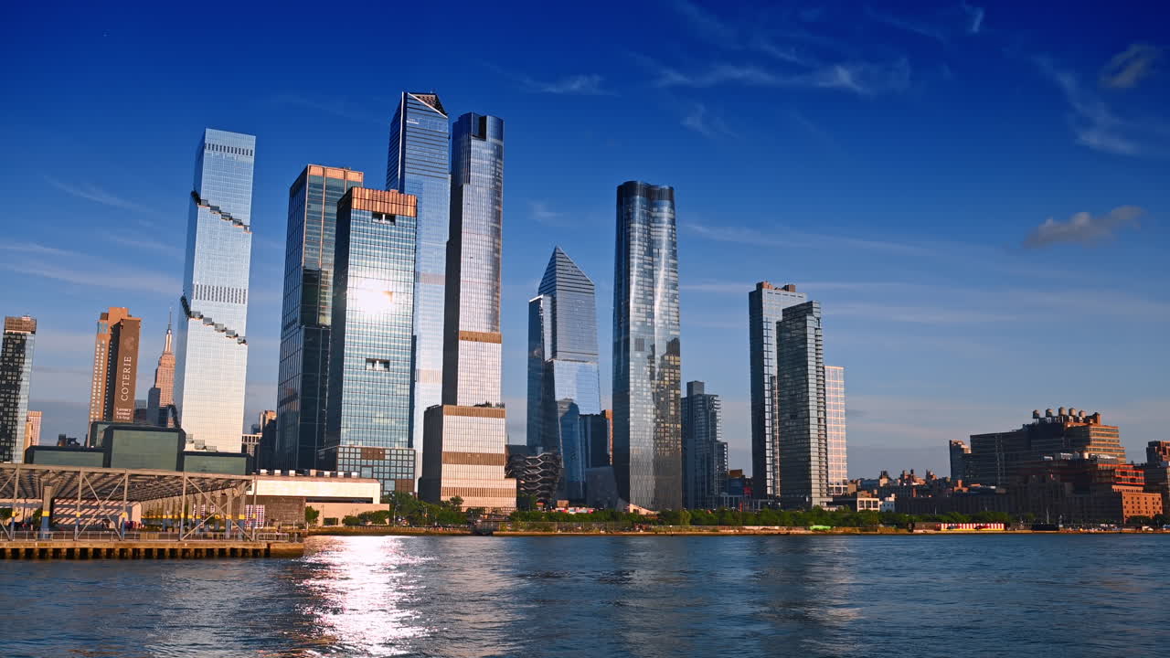 New York, USA, 1 August 2025: Stunning glass skyscrapers around the Vessel Structure in the skyline of New York, USA. Watching the metropolis from the East River waterfront