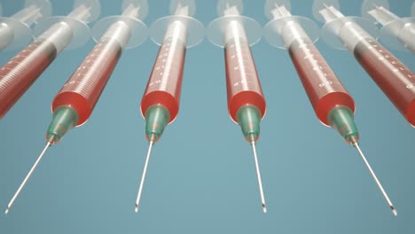 Seamless-looping-animation-with-syringes-arranged-in-a-row-with-needles-pointed-towards-camera.-Clear-plastic-disposable-syringes-filled-with-red-liquid-or-blood-against-blue-background.-4K