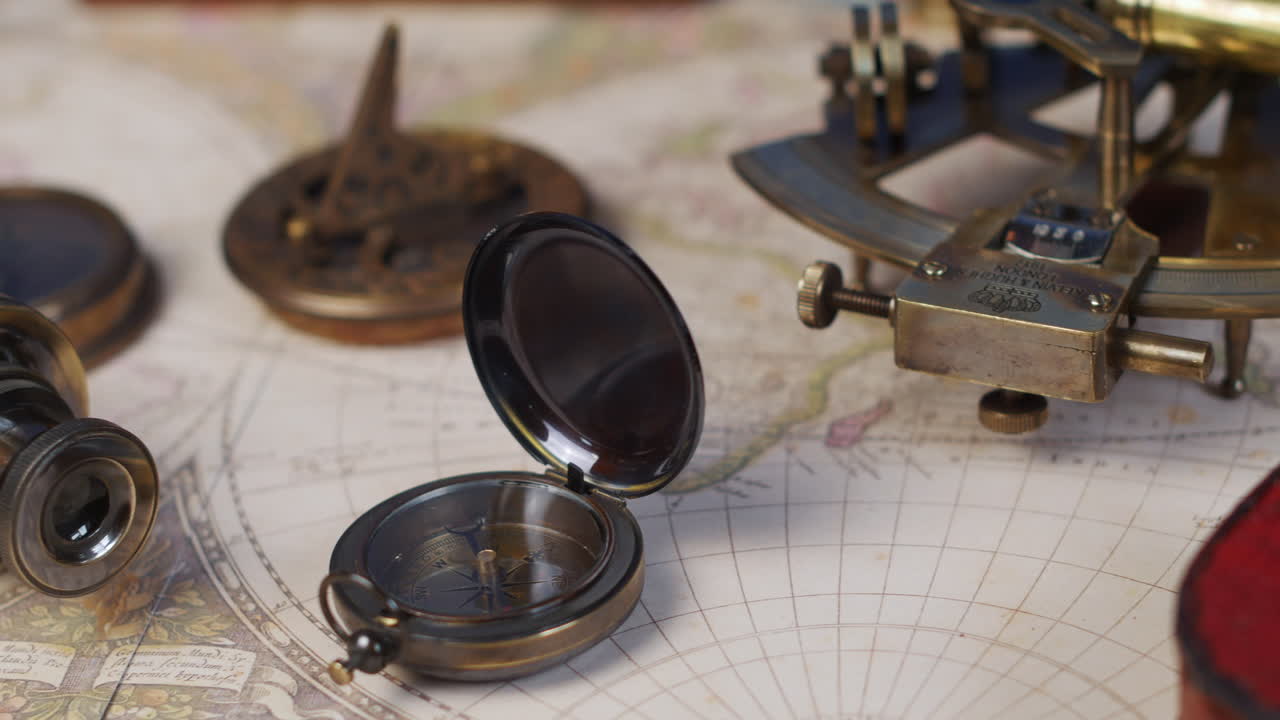 Vintage compass, telescope and a nautical sextant lying on ancient world map