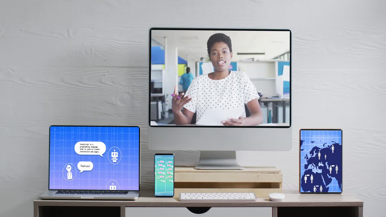 African american businesswoman on video call and electronic devices with data processing on screens