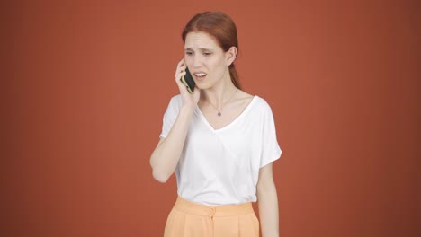 woman getting bad news on the phone gets upset.