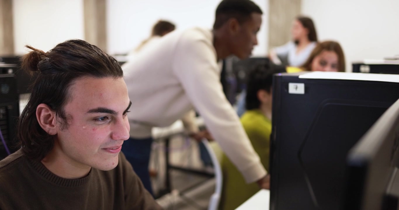Young Man Working on Computer in University Computer Lab