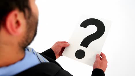 businessman holding paper with question mark sign