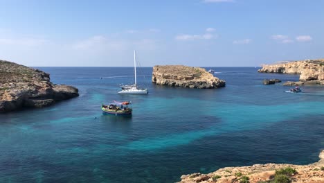 Destino-De-Vacaciones-De-Viaje-A-La-Isla-De-Comino-Velero-Amarrado-En-La-Prístina-Orilla-Del-Agua-Del-Océano