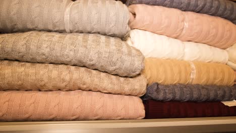 beautifully folded woolen sweaters in the closet beautifully folded woolen sweaters in the closet warm winter clothes slow motion