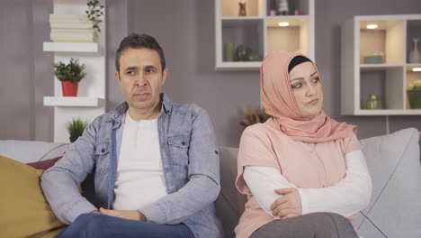 family problems. muslim woman in hijab and her husband resent each other.