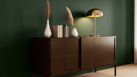 modern credenza with pampas grass and gold lamp against a green wall
