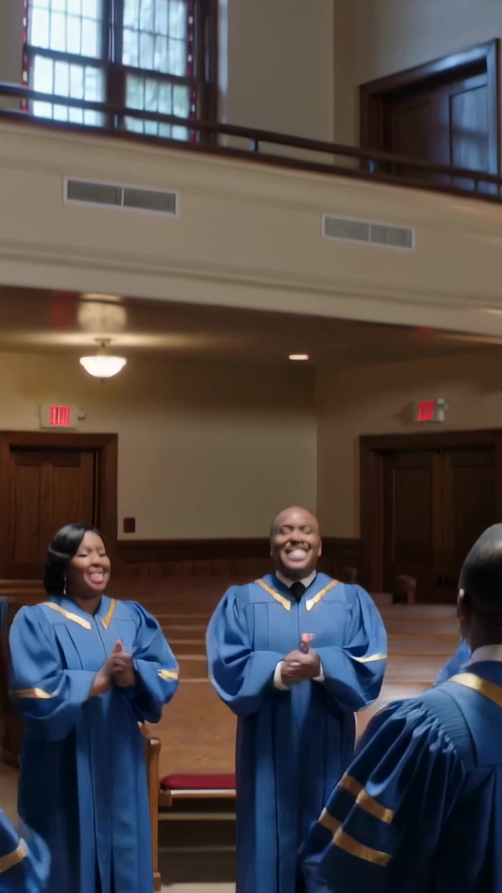 Vertical video: Following conductor cue choir in blue robes singing, clapping by door for worship