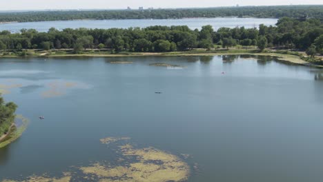 Canoe-in-the-Middle-of-a-Lake-on-a-Summer-Day,-Aerial-Drone