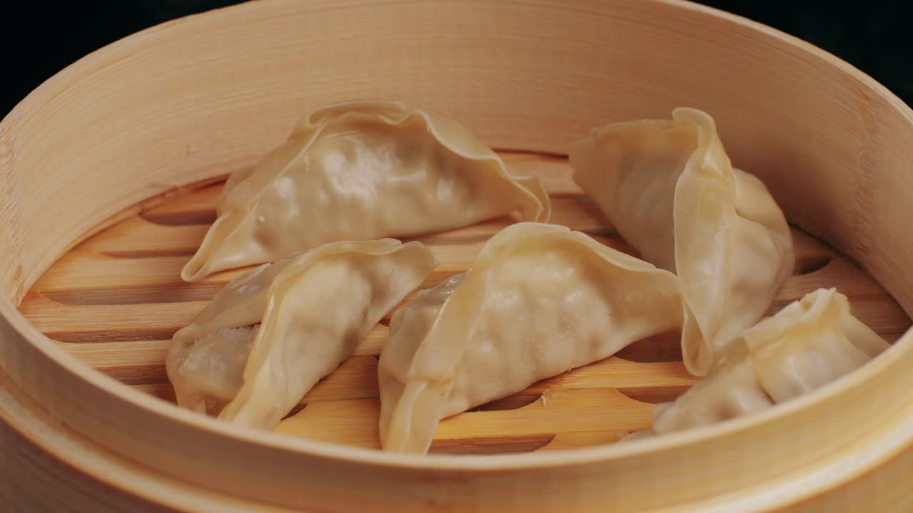 Japanese gyoza on boiling pan with oil close-up. Dumplings with meat pouring red sweet chilli sauce. Cooking at cafe, restaurant. HomemadeHigh quality 4k footage