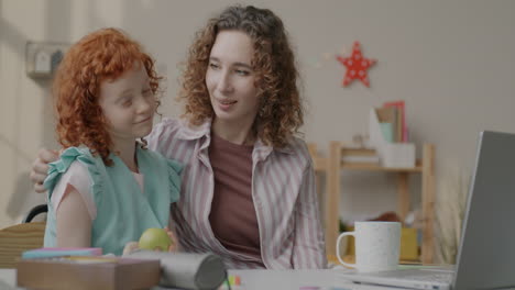 mother and daughter learning together on a laptop