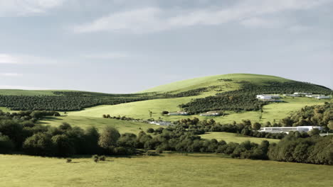 modern buildings integrated into a lush green hilly landscape