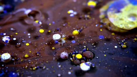 abstract colorful acrylic and food paint bubbles on water