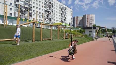 kids playing in an urban park with playground and running track