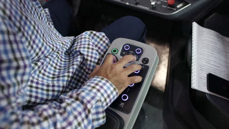 operator using controls on a vehicle's dashboard