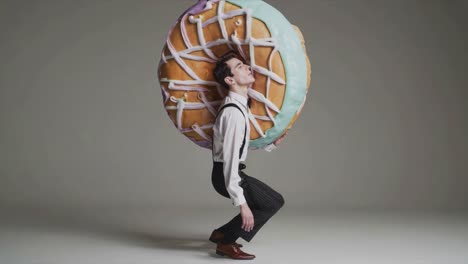 man carrying a giant donut