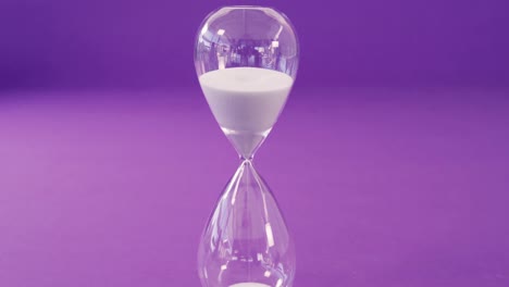 sandglass against purple background