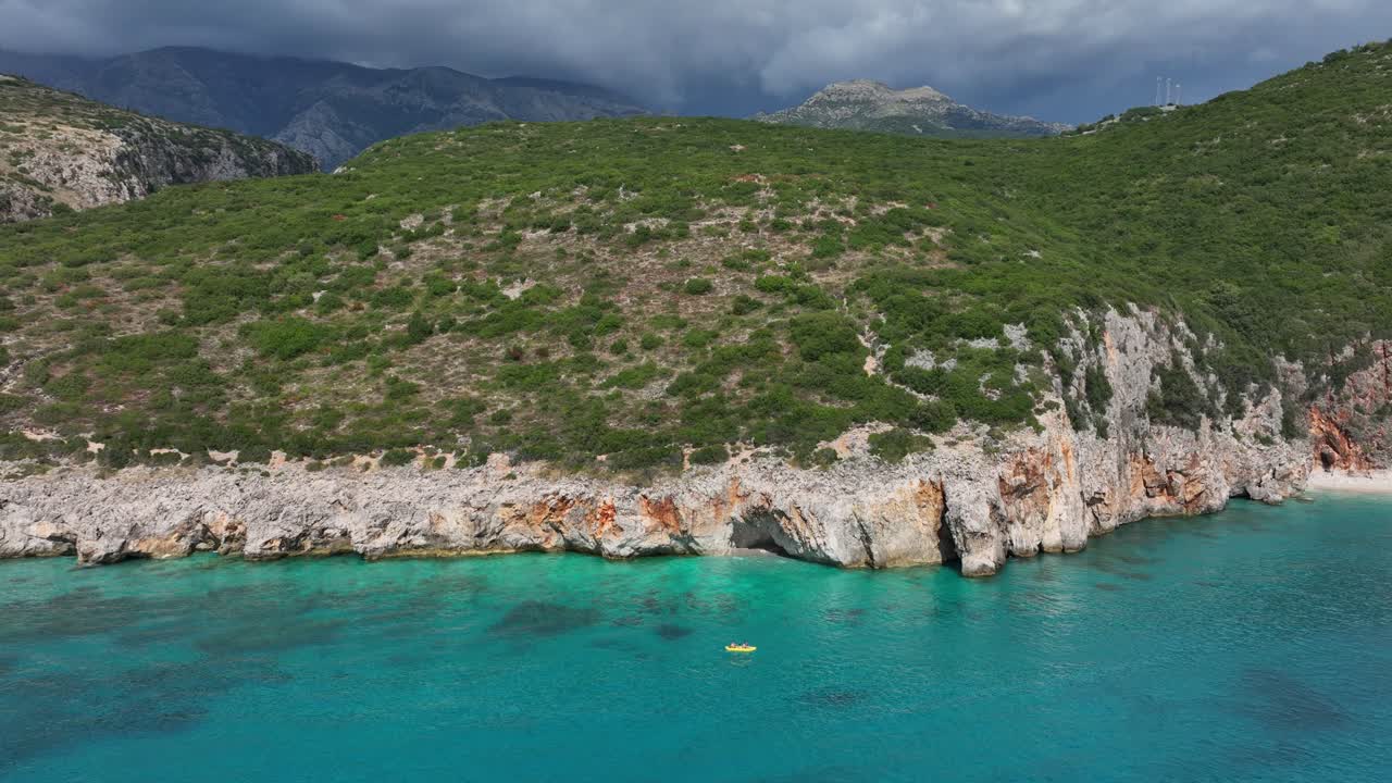 Canyon of Gjipe with Ionian Sea during the day in Vlore County, Albania, pan aerial drone shot