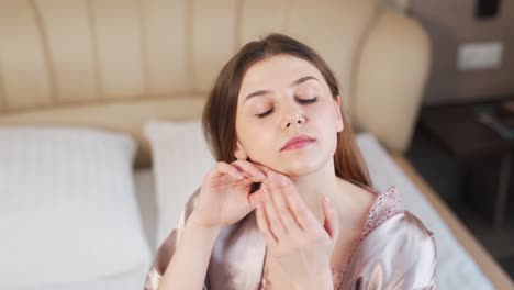 Portrait-of-a-beautiful-girl-massaging-her-face