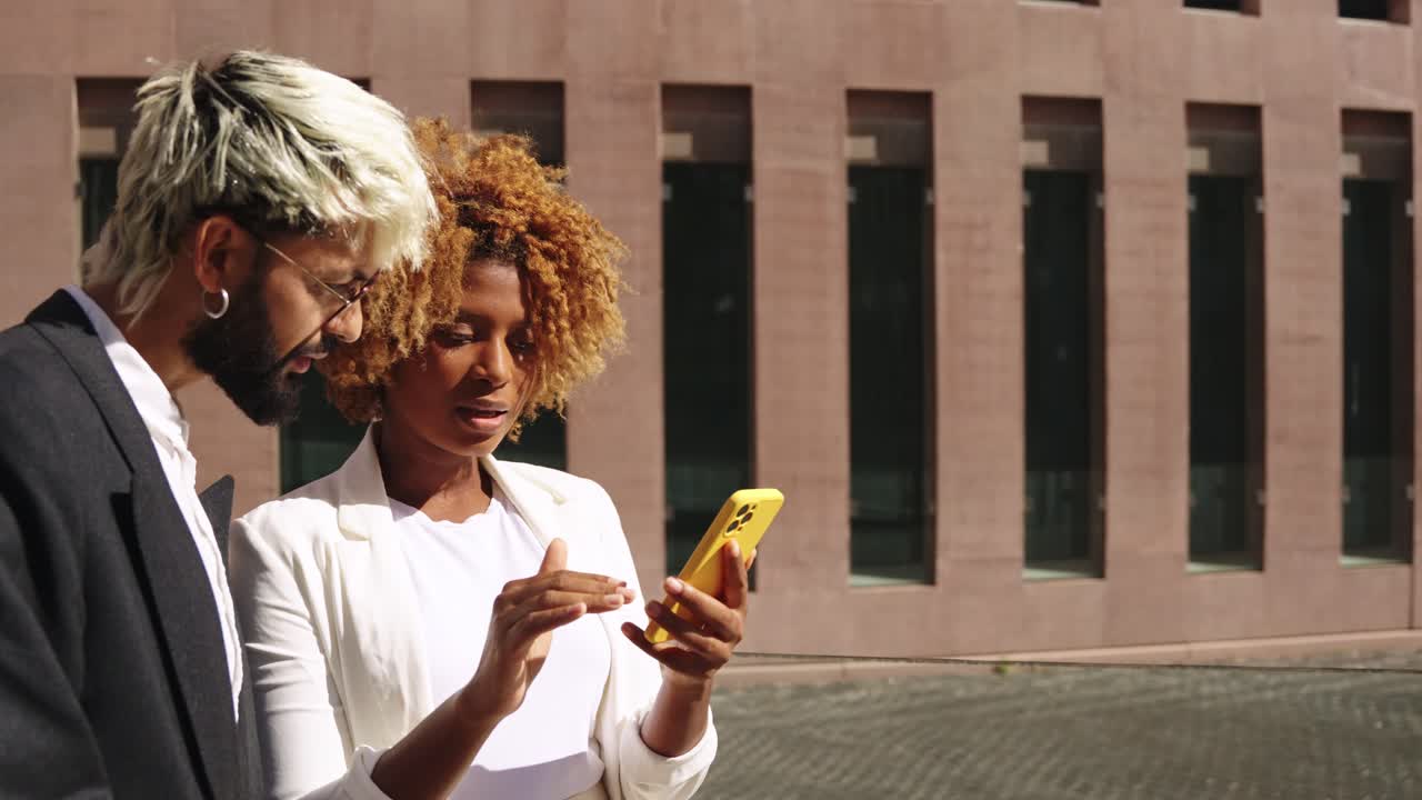 Two business people looking at a smartphone