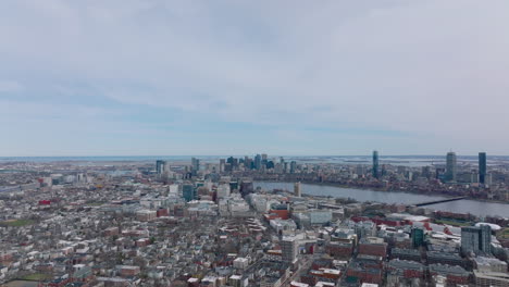 Aerial-panoramic-footage-of-metropolis-at-twilight.-Backwards-reveal-buildings-in-urban-neighbourhood.-Boston,-USA