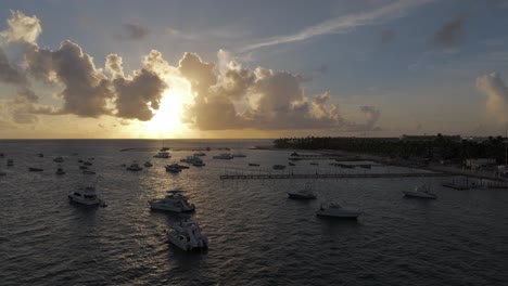 aerial view of sunset above caribbean sea, boats and yachts in cabeza de toro, punta cana, dominican republic