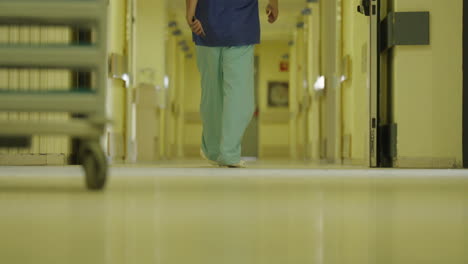 nurse walking down hospital corridor