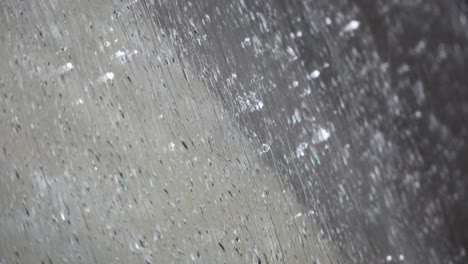 water pouring down a clean surface on a rainy day, grey color