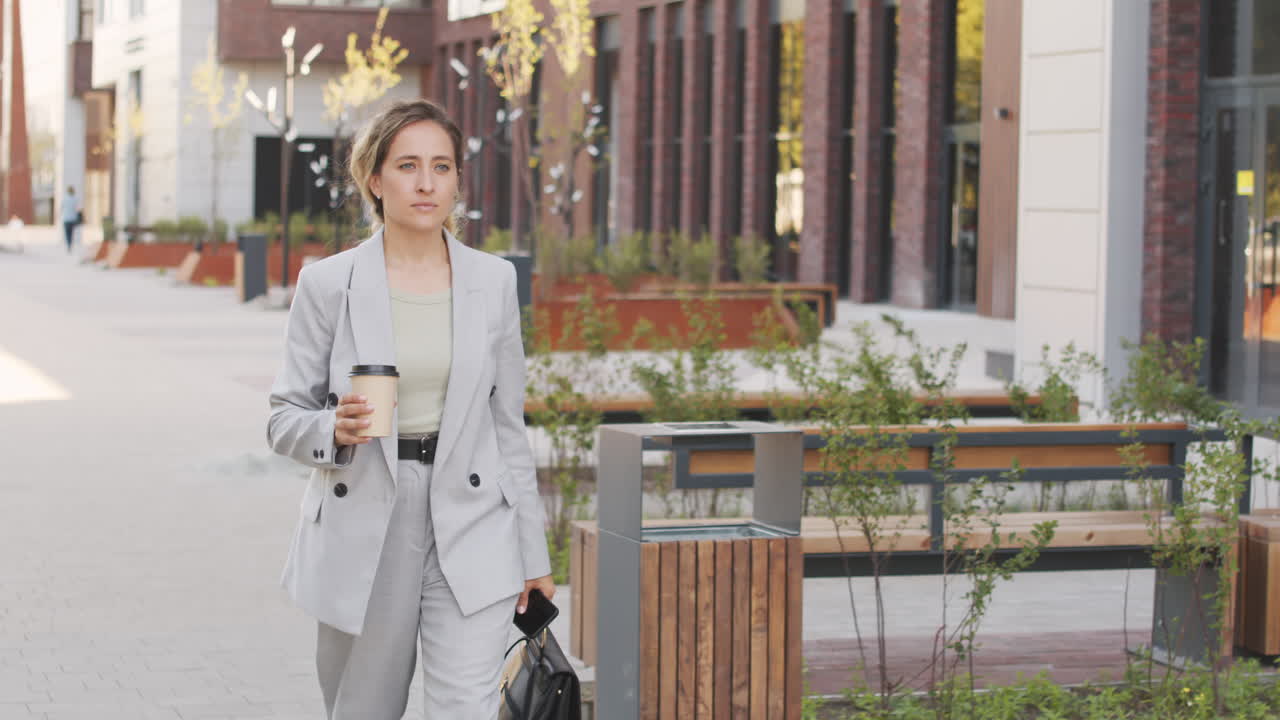 Confident Businesswoman Walking in Downtown Area
