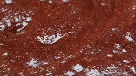 mixing chocolate cake batter with spoon