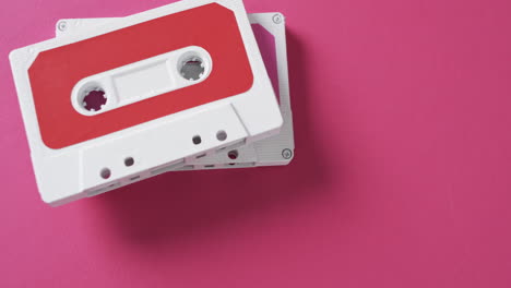 video of retro tapes with copy space on pink background