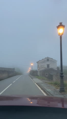 misty road with lampposts