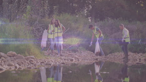 video of lights moving over happy diverse group cleaning up rubbish in countryside