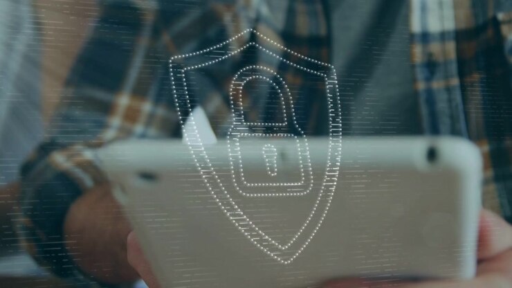 Man using tablet and tapping screen causing animated security shield over tablet securing access
