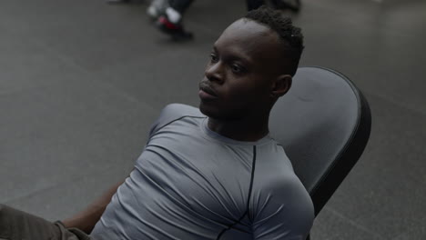 man exercising on leg press machine in a gym