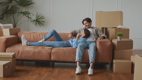 couple relaxing on sofa during move