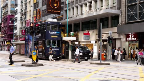 tram and pedestrians at busy city intersection