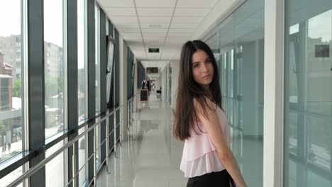 young-girl-walks-down-the-hall-with-a-notebook