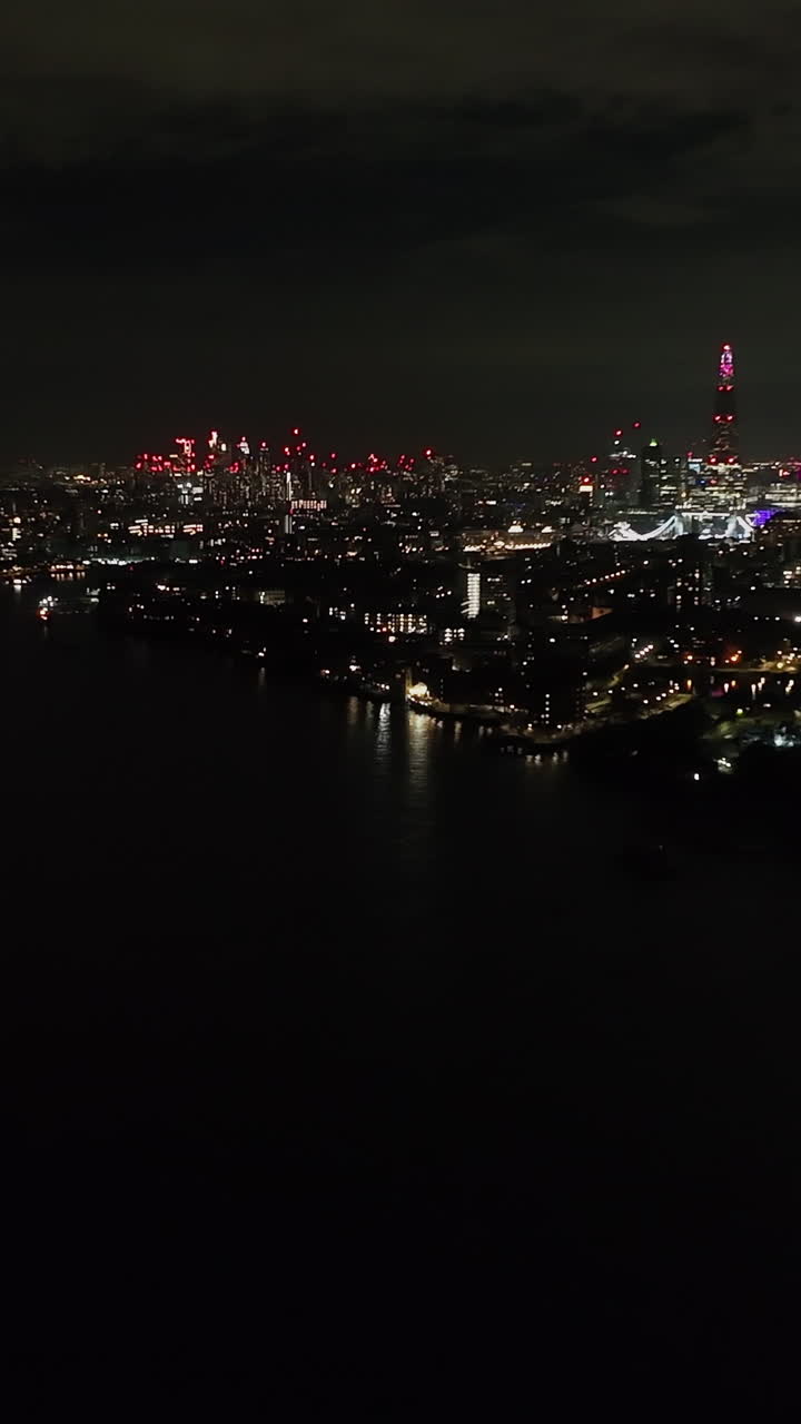 Vertical drone shot in front of the Rotherhithe neighborhood, night in London