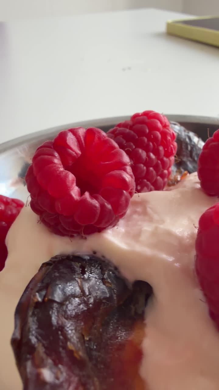 Fresh Raspberries and Dates on Creamy Yogurt in a Bowl