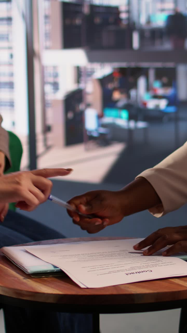 Diverse Business Partners Signing Contract and Shaking Hands