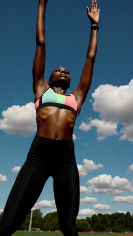 athletic woman stretching outdoors