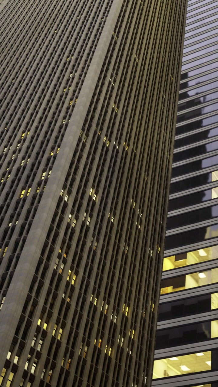 Tall buildings are reflecting light during evening in a cityscape
