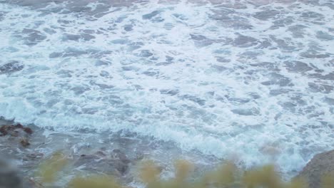 Shot-of-small-tides-coming-towards-the-shoreline-from-Isla-Mujeres-Ocean-during-daytime