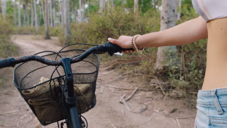 pov woman with bicycle walking on dirt road 4k