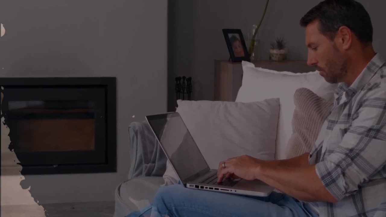 Animation of shapes over caucasian man using laptop