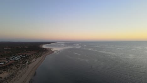 Drone-aerial-panning-above-exmouth-beach-during-dawn