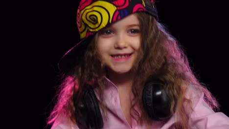 smiling child in colorful cap and headphones