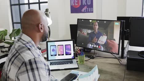 african american businessman on video call with african american male colleague on screen